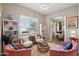 Elegant living room with stylish seating, decorative shelves, and an archway leading to the dining area at 3163 E Austin Dr, Gilbert, AZ 85296