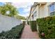 Cozy walkway lined with lush greenery and brick paving leading to the side entrance of the home at 3163 E Austin Dr, Gilbert, AZ 85296