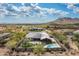 Aerial view of a desert home featuring a pool, covered patio, and meticulously landscaped backyard at 35971 N Prickley Pear Rd, Cave Creek, AZ 85331