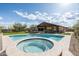 Beautiful backyard featuring a pool, covered patio, outdoor kitchen, lounge area, and playground at 35971 N Prickley Pear Rd, Cave Creek, AZ 85331