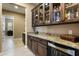 This bar area is equipped with granite counters, wood cabinets, and a beverage cooler at 35971 N Prickley Pear Rd, Cave Creek, AZ 85331