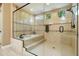 Luxurious bathroom featuring a glass-enclosed shower and separate soaking tub with neutral-toned tile work and recessed lighting at 35971 N Prickley Pear Rd, Cave Creek, AZ 85331