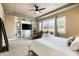 Spacious bedroom featuring built-in shelving, a TV, and a sliding glass door to the outdoor patio at 35971 N Prickley Pear Rd, Cave Creek, AZ 85331