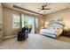 This main bedroom boasts a beamed ceiling, soft lighting, and a private balcony with a scenic view at 35971 N Prickley Pear Rd, Cave Creek, AZ 85331