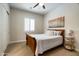 Bright bedroom featuring carpeted floors, a comfortable bed with decorative pillows, a window with shutters, and a ceiling fan at 35971 N Prickley Pear Rd, Cave Creek, AZ 85331