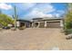 Charming home featuring a brick driveway, lush desert landscaping, and a three-car garage at 35971 N Prickley Pear Rd, Cave Creek, AZ 85331
