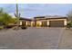 A single Gathering home exhibits a beautiful desert landscape, multi-car garage and neutral color palette at 35971 N Prickley Pear Rd, Cave Creek, AZ 85331