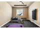 This home gym is equipped with a treadmill, weights, and a cushioned floor for a comfortable workout space at 35971 N Prickley Pear Rd, Cave Creek, AZ 85331