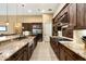 Spacious kitchen featuring custom cabinetry, granite countertops, and stainless steel appliances at 35971 N Prickley Pear Rd, Cave Creek, AZ 85331