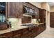 Gourmet kitchen featuring a six-burner stove, stainless steel range hood, and beautiful custom cabinets at 35971 N Prickley Pear Rd, Cave Creek, AZ 85331