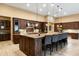 Stunning kitchen with a large island, custom cabinetry, granite countertops, and stainless steel appliances at 35971 N Prickley Pear Rd, Cave Creek, AZ 85331