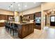 Gourmet kitchen with custom cabinets, stainless steel appliances, and a large island with barstool seating at 35971 N Prickley Pear Rd, Cave Creek, AZ 85331