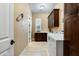 Spacious laundry room with dark wood cabinetry, tiled floor, sink, and modern washer and dryer at 35971 N Prickley Pear Rd, Cave Creek, AZ 85331
