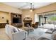 Comfortable living room featuring a fireplace, built-in shelving, and seamless access to outdoor spaces at 35971 N Prickley Pear Rd, Cave Creek, AZ 85331