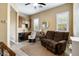 Inviting living room features a comfortable recliner sofa, a wet bar, hardwood floors, and bright natural lighting at 35971 N Prickley Pear Rd, Cave Creek, AZ 85331