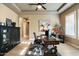 This home office features a wooden desk, cabinet, and an interesting and colorful cow painting at 35971 N Prickley Pear Rd, Cave Creek, AZ 85331