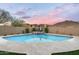 Backyard pool with spa and cascading waterfall feature surrounded by well maintained landscaping and desert views at 35971 N Prickley Pear Rd, Cave Creek, AZ 85331