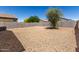 Expansive gravel backyard, fenced in, ready for personalized landscaping or recreation at 36454 W Picasso St, Maricopa, AZ 85138