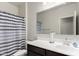 Well-maintained bathroom with a dark vanity and shower-tub combination at 36454 W Picasso St, Maricopa, AZ 85138