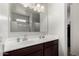 Bathroom featuring double sinks, chrome fixtures, and dark wood cabinets at 36454 W Picasso St, Maricopa, AZ 85138