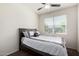 Well-lit bedroom with a cozy bed, window, and ceiling fan provides a relaxing retreat at 36454 W Picasso St, Maricopa, AZ 85138