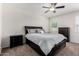 Comfortable bedroom with a ceiling fan, carpet flooring, and dark wood furniture at 36454 W Picasso St, Maricopa, AZ 85138