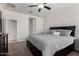 This bedroom features carpet flooring, a ceiling fan, and a dark wood dresser at 36454 W Picasso St, Maricopa, AZ 85138