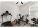 Bright exercise room featuring modern equipment, with natural light and carpet flooring at 36454 W Picasso St, Maricopa, AZ 85138