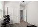 Bright exercise room featuring modern equipment, with natural light and carpet flooring at 36454 W Picasso St, Maricopa, AZ 85138