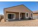Rear exterior of the home with a covered patio and low-maintenance gravel yard at 36454 W Picasso St, Maricopa, AZ 85138