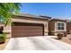 Single-story home featuring a two car garage and a low-maintenance xeriscaped front yard at 36454 W Picasso St, Maricopa, AZ 85138
