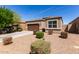 Charming single-story home featuring a two car garage and a well-maintained xeriscaped front yard at 36454 W Picasso St, Maricopa, AZ 85138