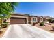 Well-maintained single-story home featuring a two car garage and a xeriscaped front yard at 36454 W Picasso St, Maricopa, AZ 85138