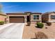 Beautiful single-story home featuring a two car garage and a well-maintained xeriscaped front yard at 36454 W Picasso St, Maricopa, AZ 85138