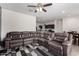 Spacious living room featuring a comfortable sectional sofa and an open floor plan at 36454 W Picasso St, Maricopa, AZ 85138
