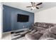 Living room featuring a comfortable sectional sofa and a modern ceiling fan at 36454 W Picasso St, Maricopa, AZ 85138