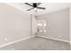 Bright bedroom with carpeted floors, ceiling fan, and window overlooking the yard at 3752 W Becker Ln, Phoenix, AZ 85029