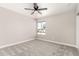 Empty bedroom featuring a ceiling fan, window, and neutral colored walls and carpet at 3752 W Becker Ln, Phoenix, AZ 85029