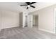Neutral bedroom with carpeted floors, ceiling fan, and large mirrored closet at 3752 W Becker Ln, Phoenix, AZ 85029