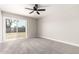 Spacious bedroom with carpeted floors, ceiling fan, and sliding glass door to the backyard at 3752 W Becker Ln, Phoenix, AZ 85029