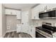 Well-equipped kitchen includes stainless steel oven, microwave, and marble countertops at 3752 W Becker Ln, Phoenix, AZ 85029