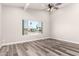 Bright living room with modern vinyl floors, neutral paint, ceiling fan, and large window at 3752 W Becker Ln, Phoenix, AZ 85029