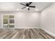 Bright living room with modern vinyl floors, neutral paint, ceiling fan, and access to the backyard at 3752 W Becker Ln, Phoenix, AZ 85029