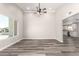Bright, spacious living room with modern vinyl floors, neutral paint, a ceiling fan, and ample natural light at 3752 W Becker Ln, Phoenix, AZ 85029