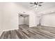 Bright, spacious living room with modern vinyl floors, neutral paint, ceiling fan, and open layout at 3752 W Becker Ln, Phoenix, AZ 85029