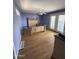 A bare bedroom featuring hardwood floors, a ceiling fan, light purple walls, and exterior access at 3914 E Andorra Dr, Phoenix, AZ 85032