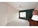 Bright bedroom featuring a vaulted ceiling, large window, and neutral color scheme at 4081 N 156Th Dr, Goodyear, AZ 85395