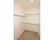 Interior view of a reach-in closet, showcasing ample storage space with rods and shelving at 4081 N 156Th Dr, Goodyear, AZ 85395