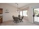 Bright dining area featuring a chandelier, bay window, and access to the patio at 4081 N 156Th Dr, Goodyear, AZ 85395