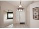 Inviting foyer featuring neutral tile flooring, a transom window, and an art niche at 4081 N 156Th Dr, Goodyear, AZ 85395